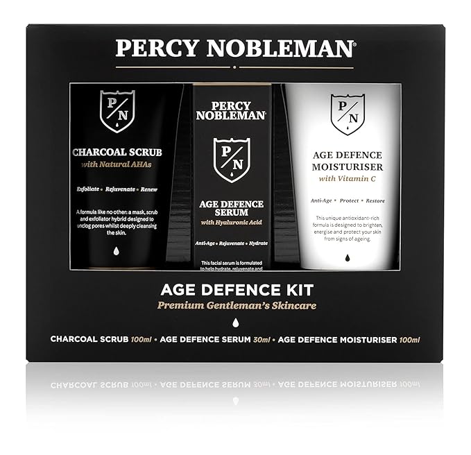Age Defence Kit, a men's skincare set containing Charcoal Face Scrub (with Natural AHAs), ultra-hydrating Facial Serum (with Hyaluronic Acid), and Moisturiser (with Vitamin C)